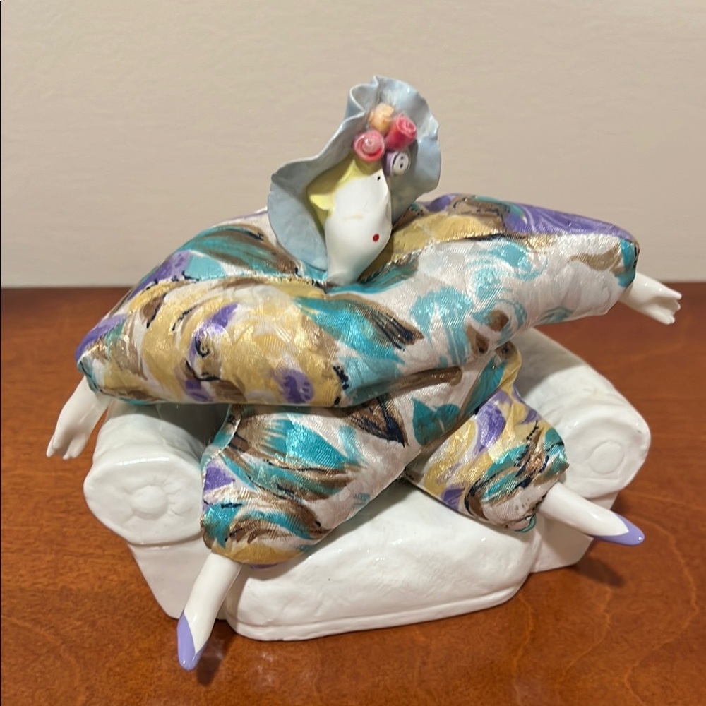 Colorful Ceramic Figurine on White Couch